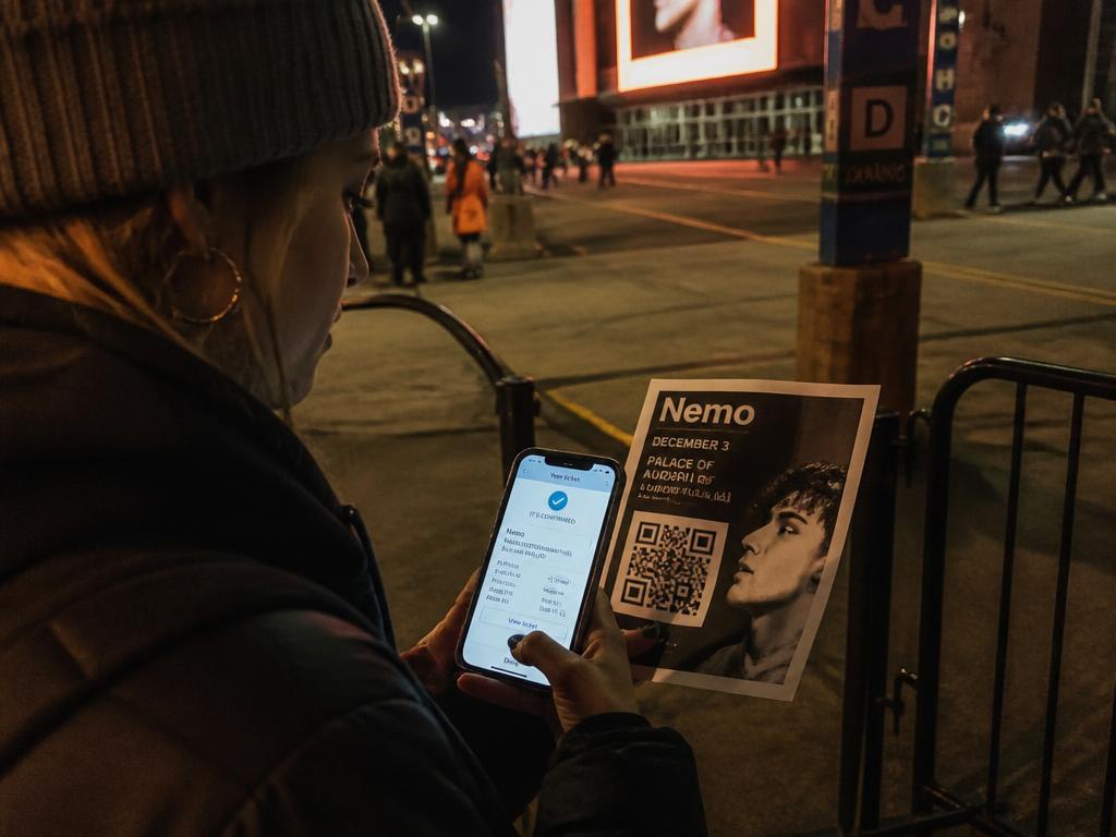 Fan outside an arena scanning a QR code on a printed flyer to buy a ticket
